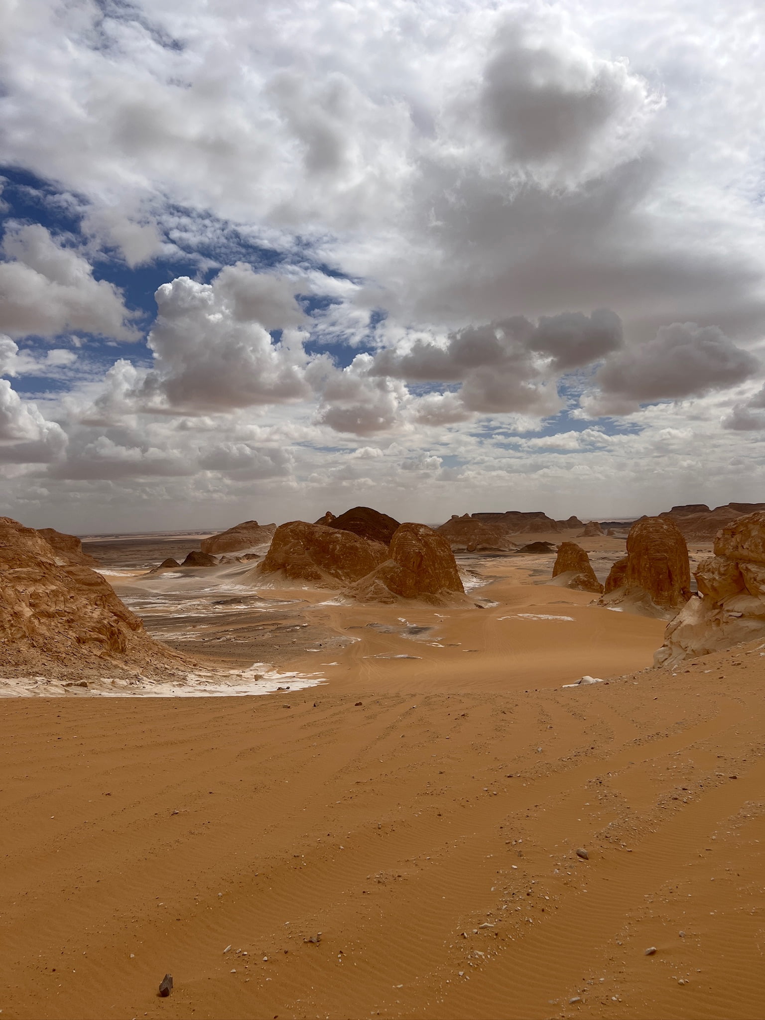 Egyptian Sahara, with a sky covered of white clouds.