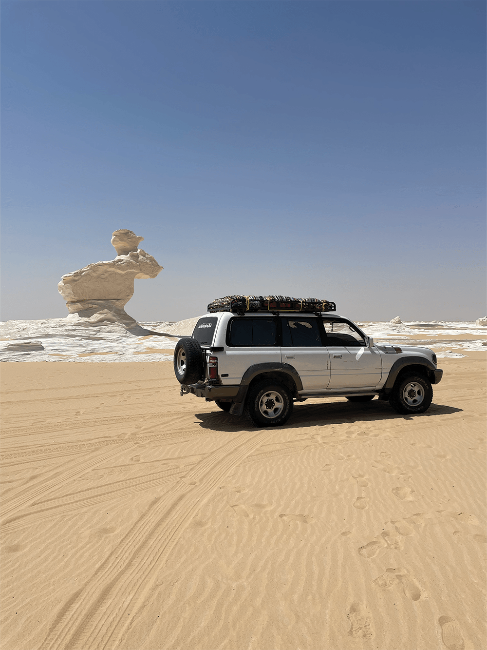 Egyptian Sahara, Toyota 4x4 in front of white desert.