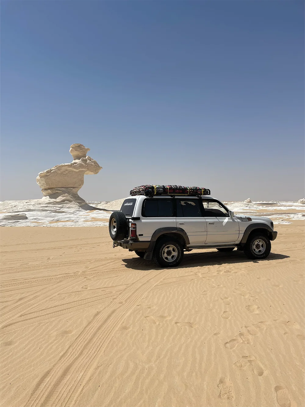 Egyptian Sahara, Toyota 4x4 in front of white desert Egyptian Sahara, Toyota 4x4 in front of white desert.